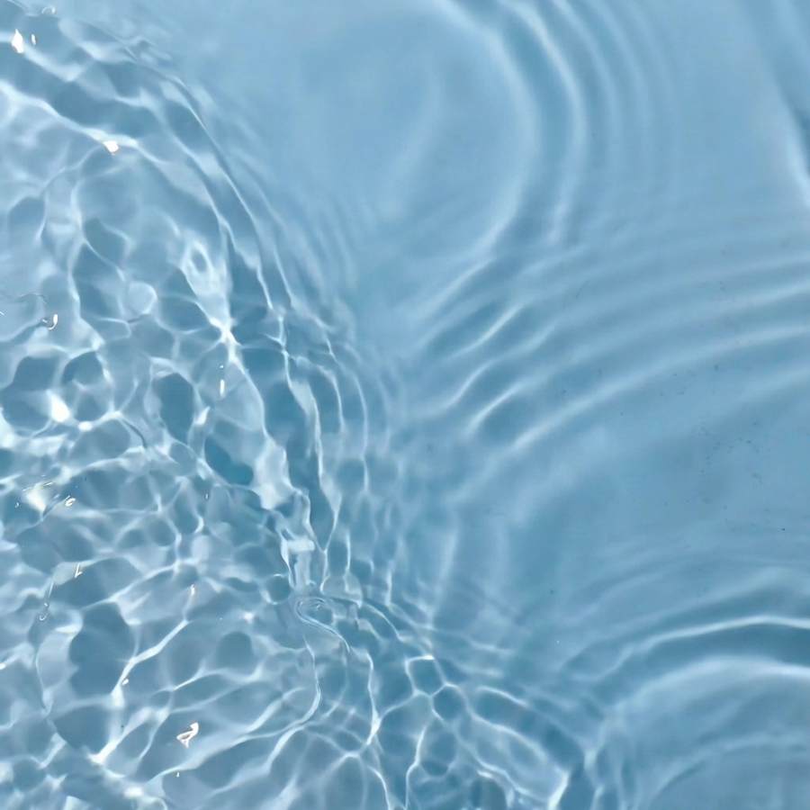 Tranquil turquoise water with gentle ripples, perfect for refreshing summer vibes and relaxation.